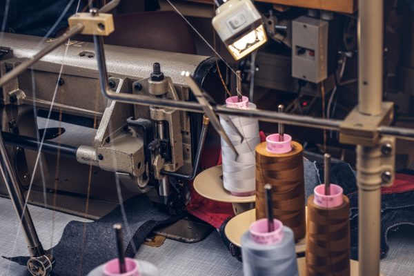 Picture of a tailor's desktop at a sewing workshop.